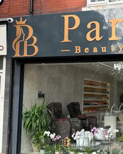 Pari Beauty shopfront on Manchester Road, Chorlton, with gold lettering above the salon window